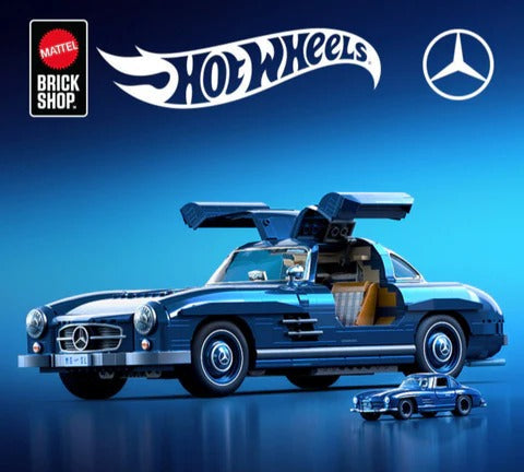 Mattel Brick Shop Hot Wheels Mercedes-Benz collaboration featuring a blue SLS roadster car with open gull doors, shown alongside a small matching car and the Hot Wheels and Mercedes-Benz logos on a blue gradient background with the text 'BUILT DIFFERENT'.